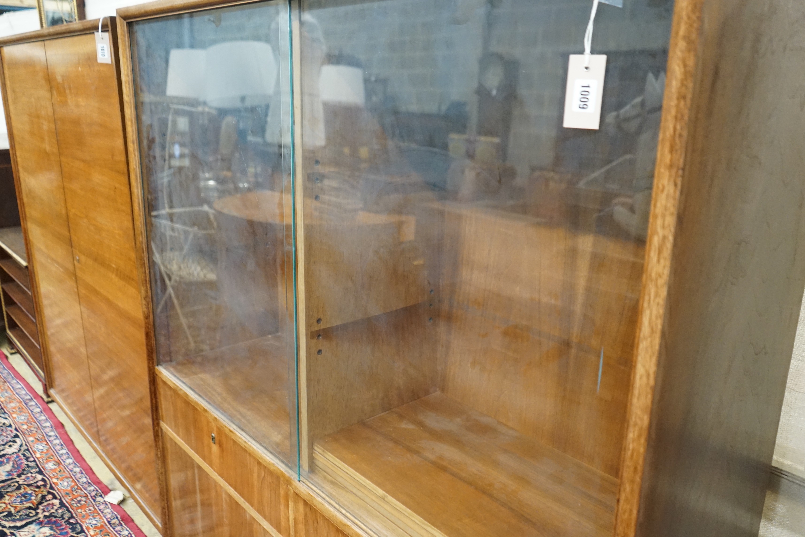 A mid century walnut bookcase by Georg Schoettle, Stuttgart, width 135cm, depth 40cm, height 160cm